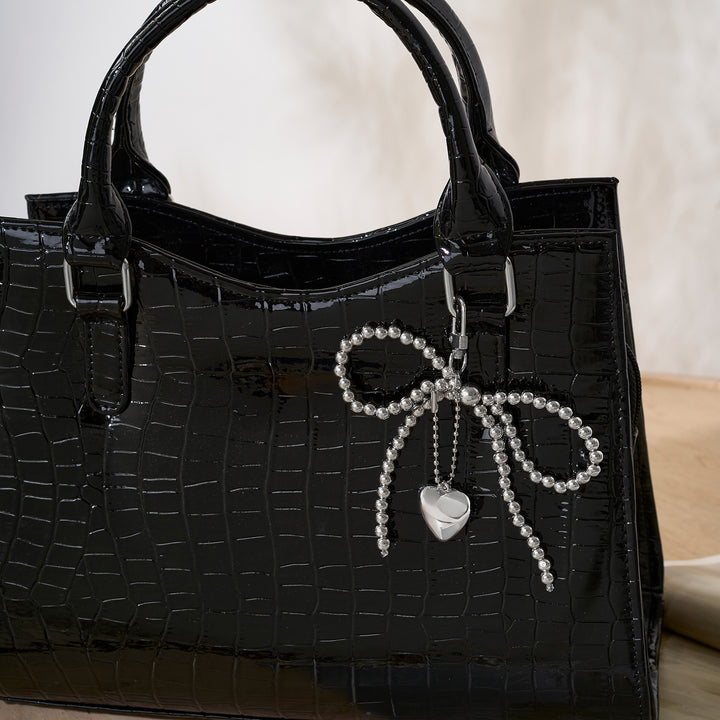 A Bow-Crush Silver Bag Charm